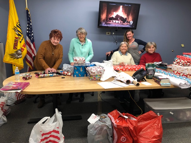 TREA employees wrapping gifts to provide holiday help for military families