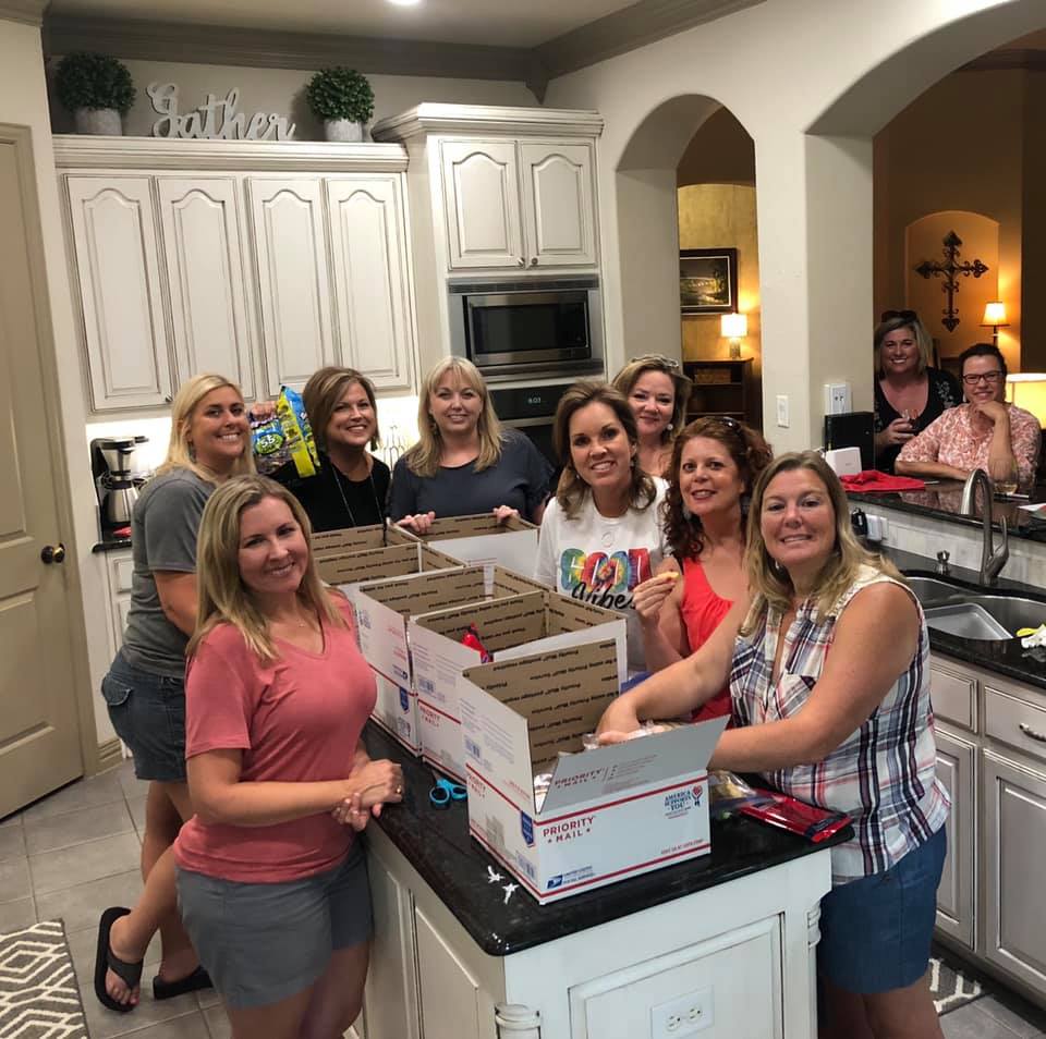 After baking for the troops, the group pack the goods into care packages before shipping overseas.