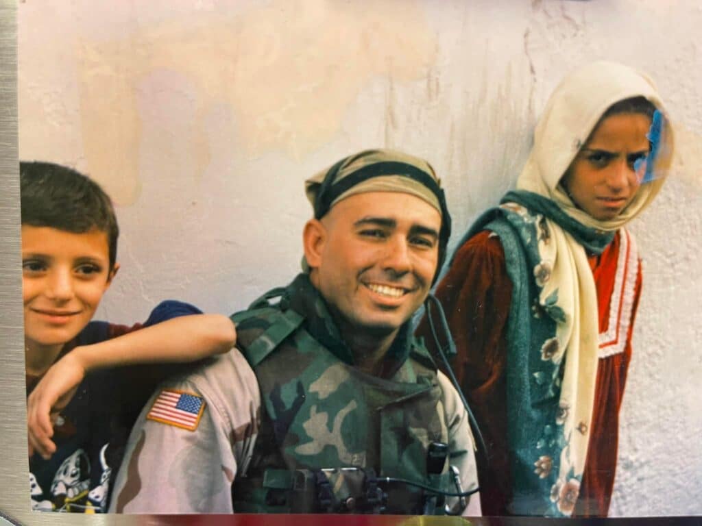 Darrin with children in Iraq during humanitarian missions.