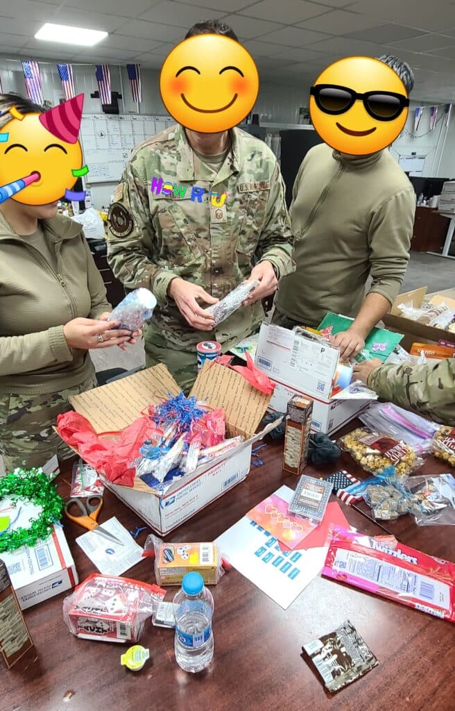 Service Members opening care packages at a table