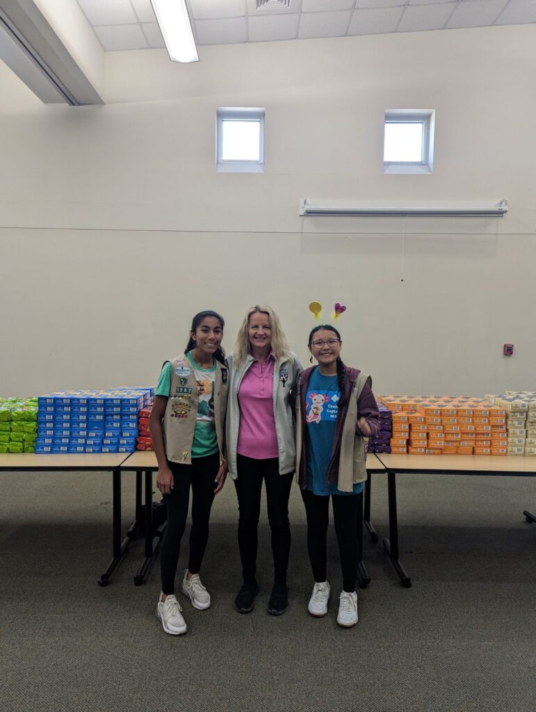 CEO Amy Palmer with two Girl Scouts