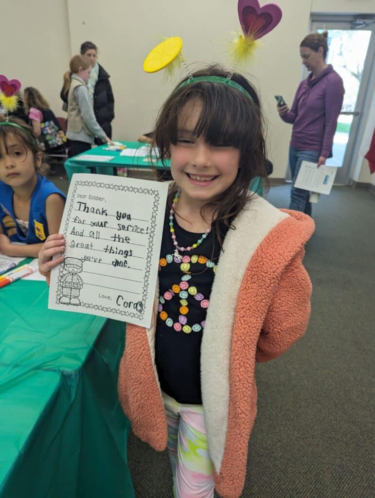 Girl Scout holding a thank you note