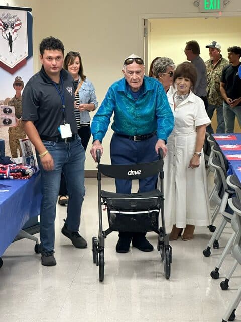 Soldiers' Angels volunteer Chris escorts Mr. Russell to his 100th birthday celebration.