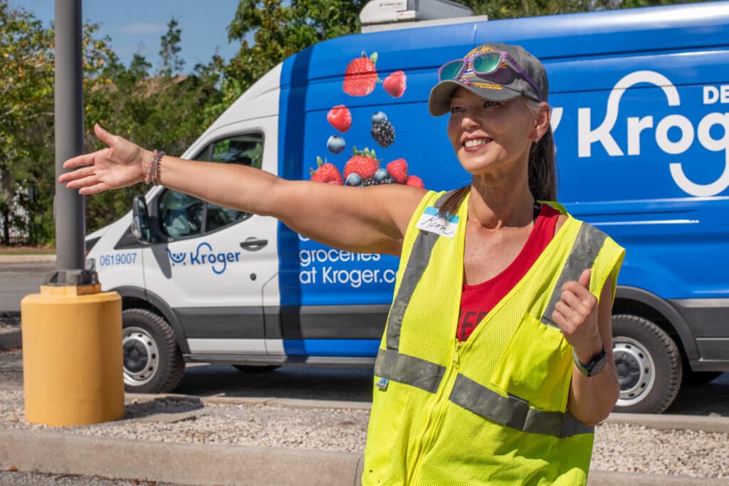 Volunteers directing traffic at the Kroger Racing food distribution event.