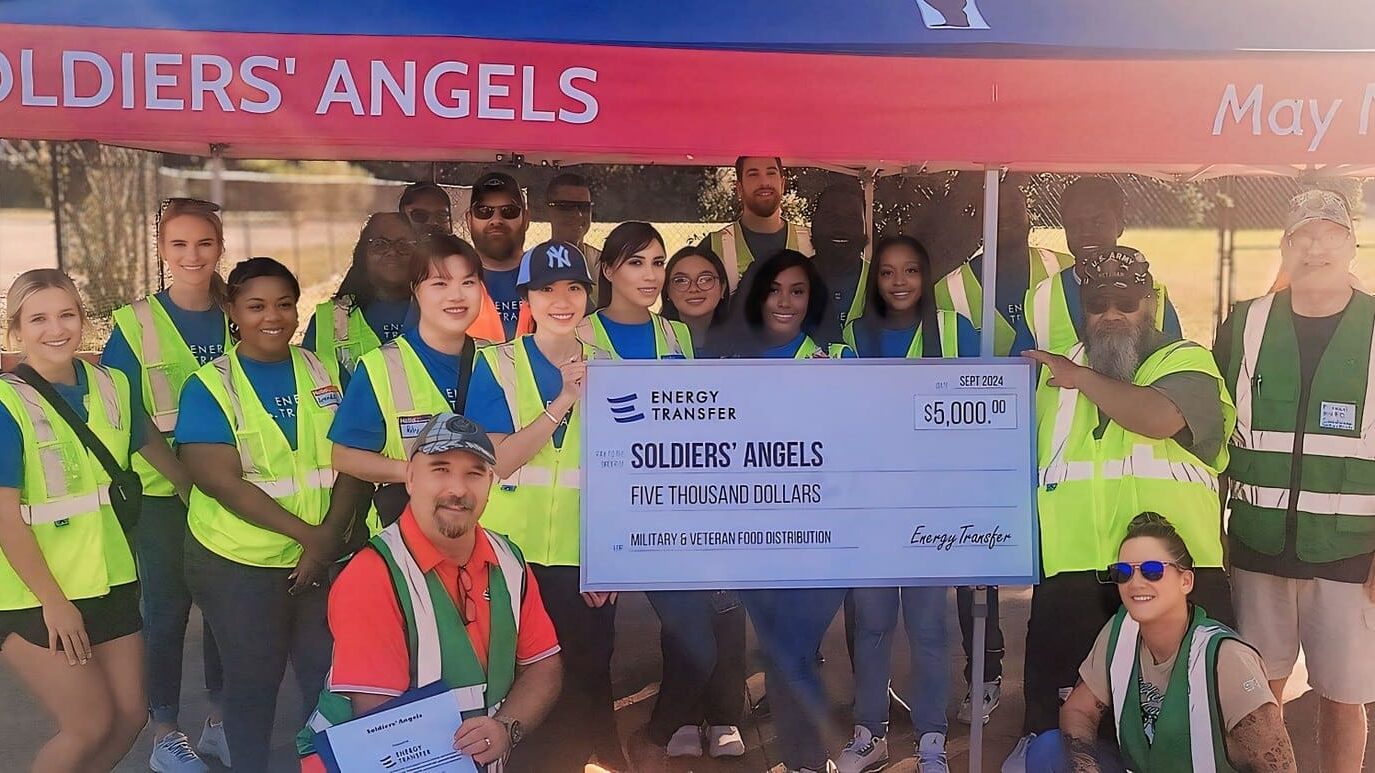 Soldiers' Angels Dallas volunteers accept a check from Energy Transfer at the 1-year Anniversary event.