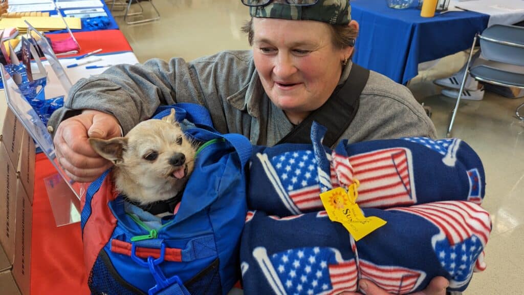 A homeless Veteran and her pup received a warm blanket from Operation: Warm Winter 2023.