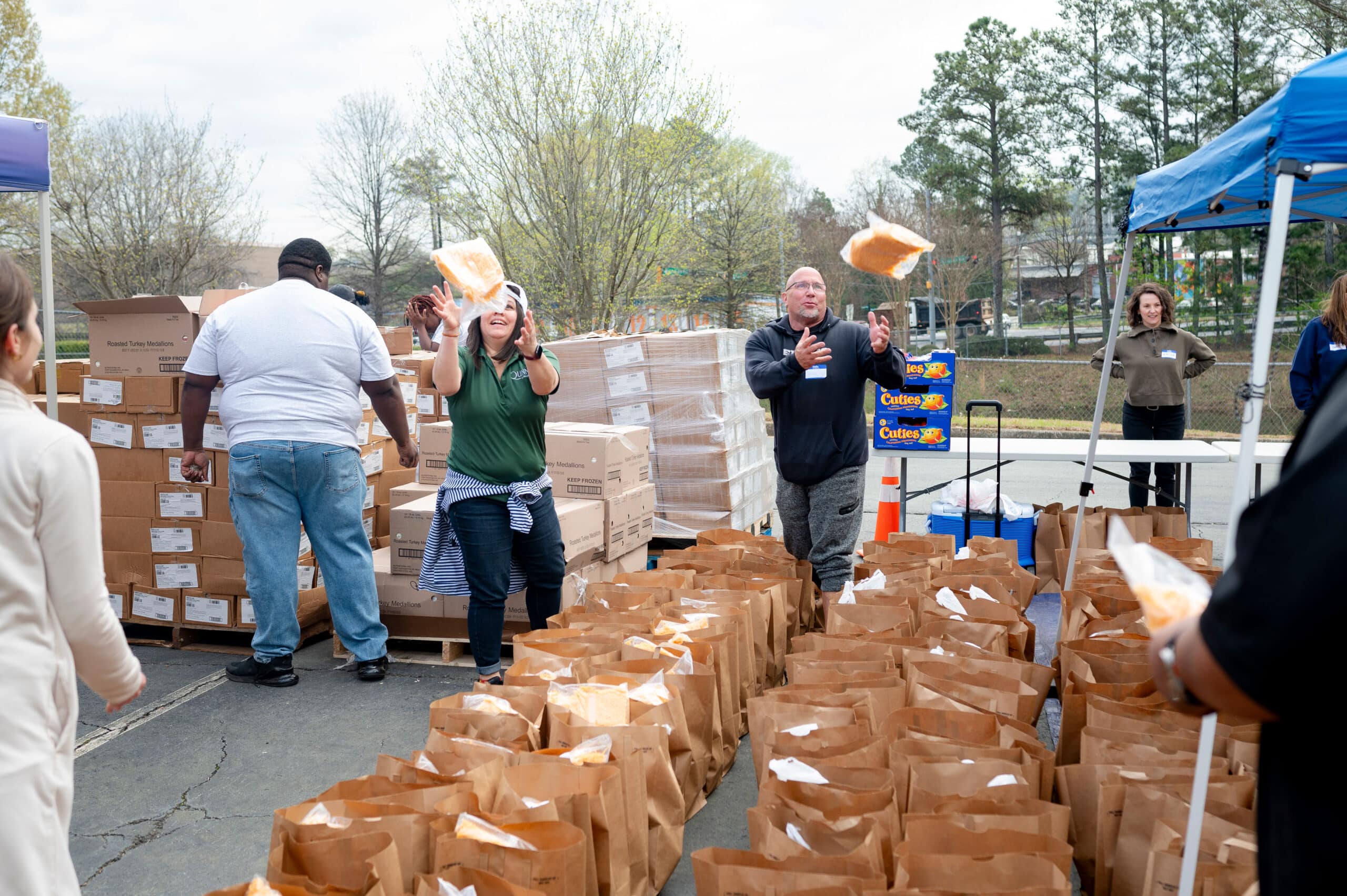 Volunteers distributing food to service members and veterans at an outdoor event