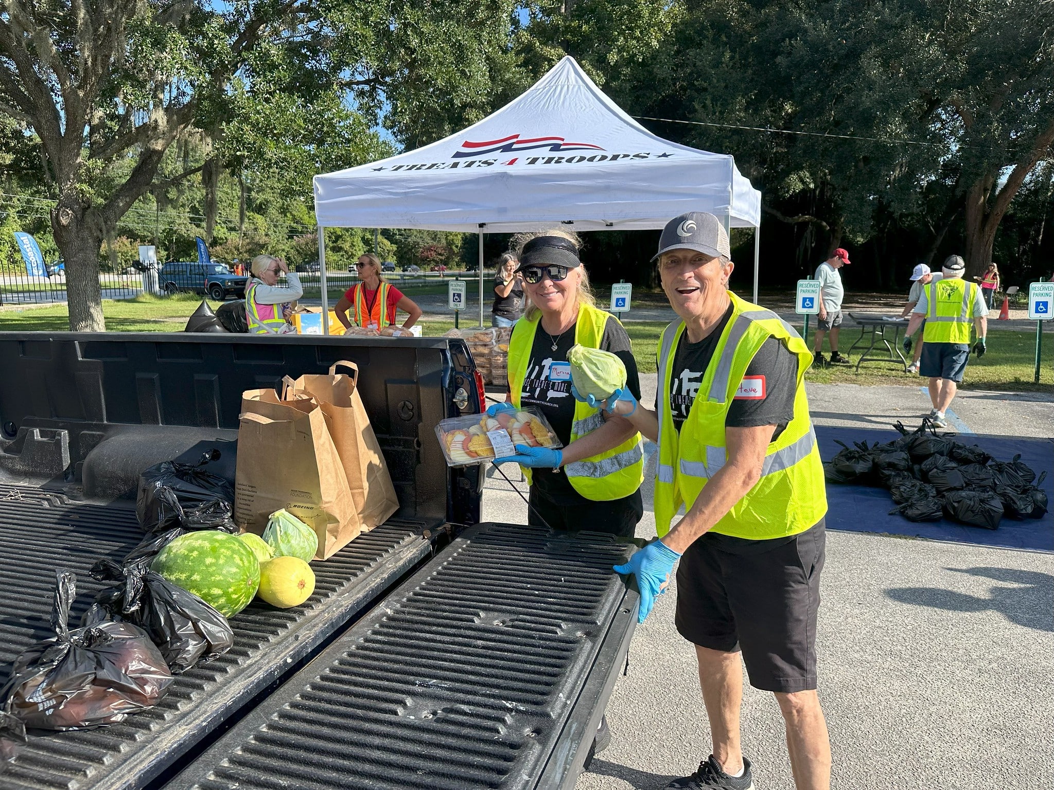 Volunteers distributing food to service members and veterans at an outdoor event