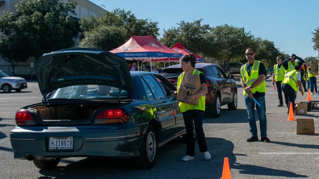 Volunteers in San Antonio load groceries
