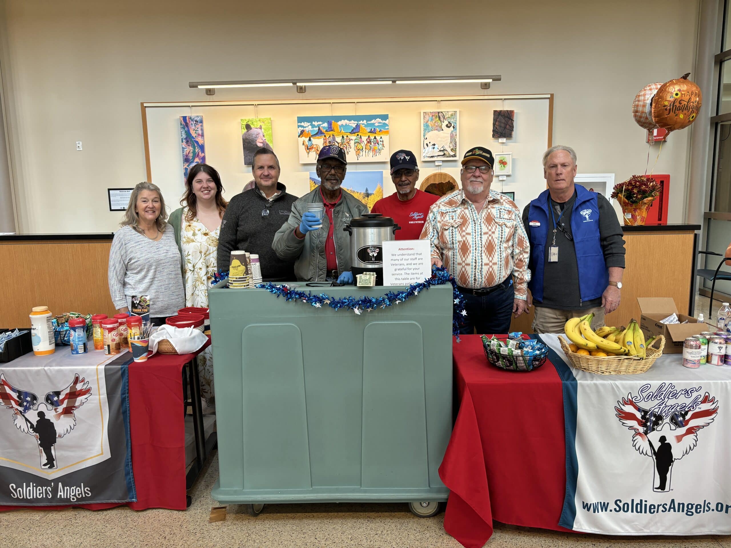 Volunteers distributing food to service members and veterans at an outdoor event