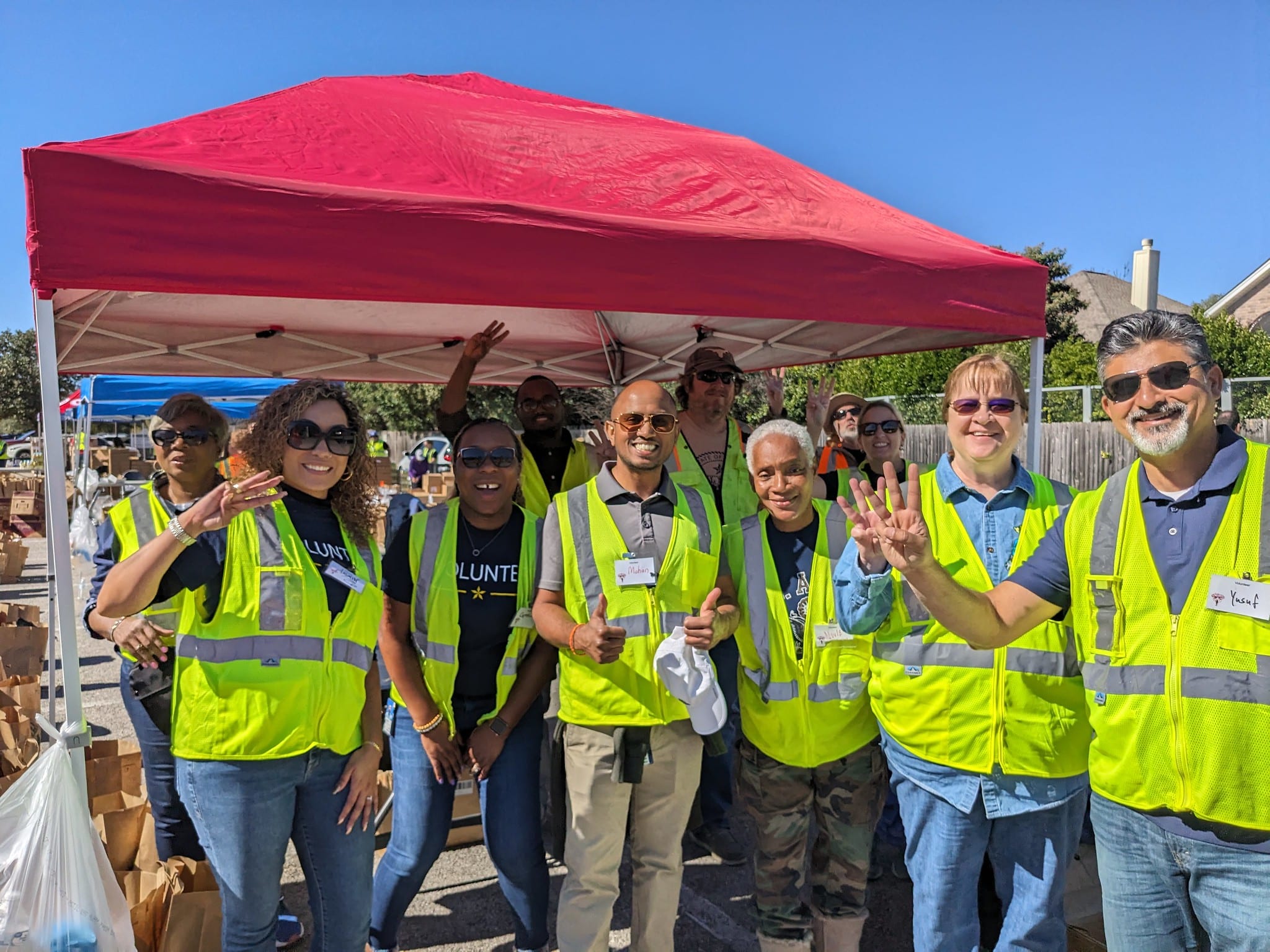 Volunteers distributing food to service members and veterans at an outdoor event