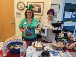 VA Hospital Representative and volunteer serve coffee and donuts