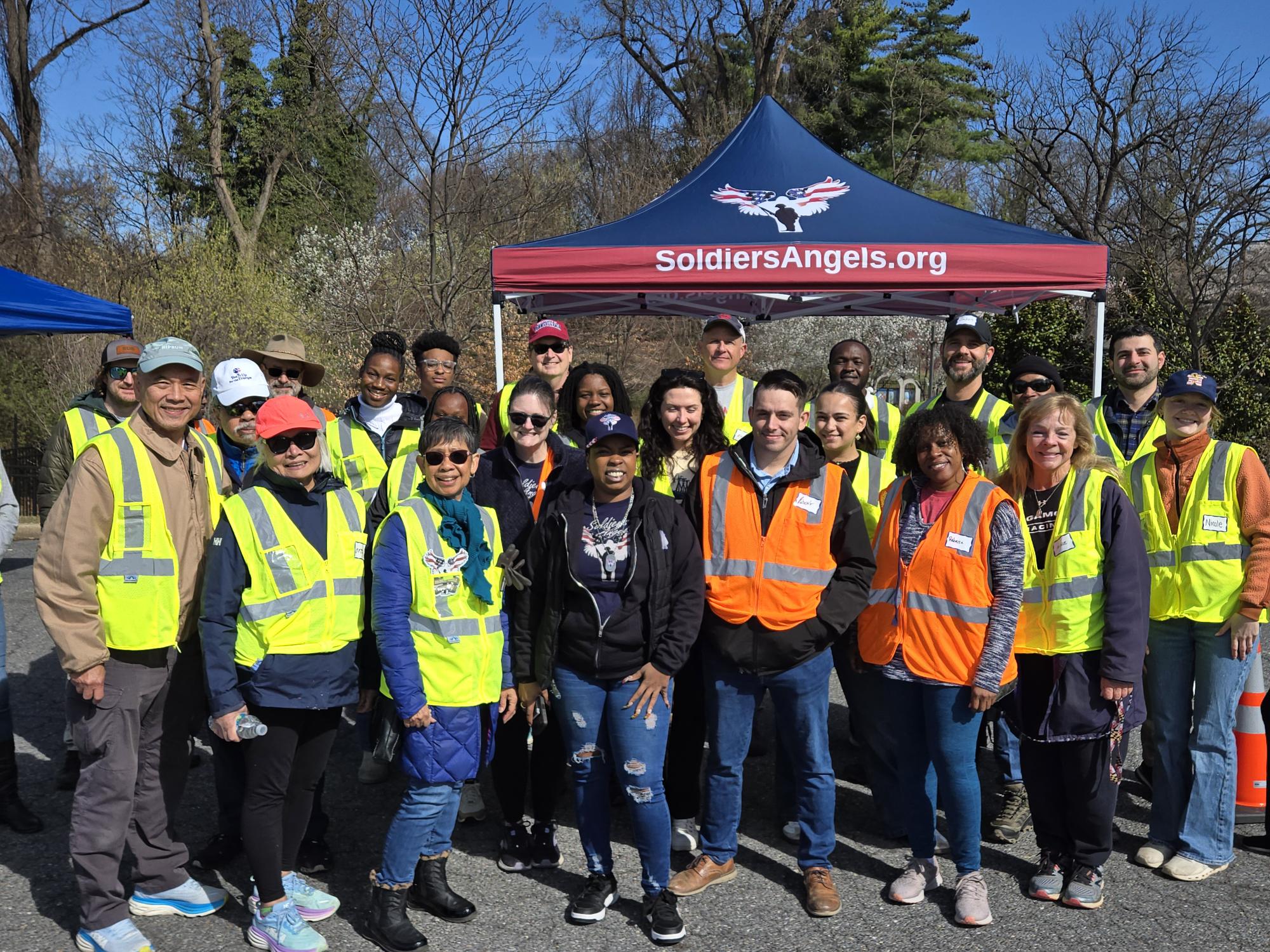 Volunteers distributing food to service members and veterans at an outdoor event